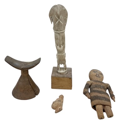 Lot 681 - An African carved wooden headrest, an African...