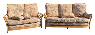 Lot 5 - ERCOL; a modern light elm spindle back three...