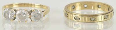 Lot 1207 - Two 9ct gold dress rings, one with three close...