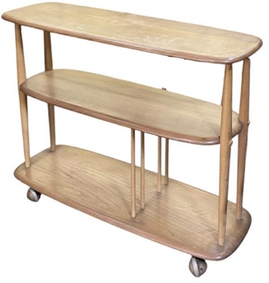 Lot 39 - ERCOL; a mid century medium elm three tiered...