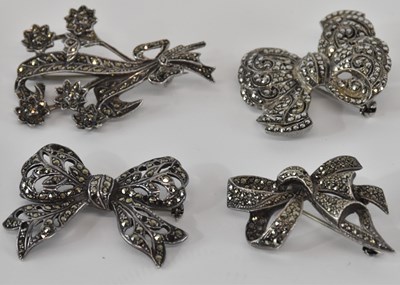 Lot 1332 - Four silver and marcasite floral decorated...