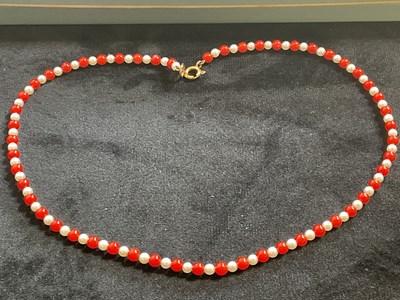 Lot 514 - A coral and cultured pearl bead necklace with...