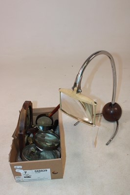 Lot 1057 - A 1920s/30s table top magnifying lens, also a...