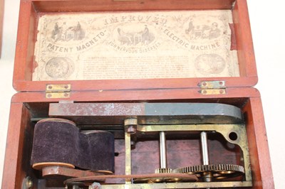 Lot 1058 - Two walnut cased patent magneto electric...