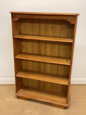 Lot 562 - A reproduction pine open bookcase with three...