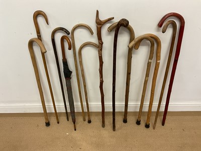 Lot 43 - Twelve walking sticks and one umbrella, of...
