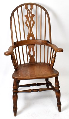 Lot 1708 - A 19th century elm seated spindle back Windsor elbow chair