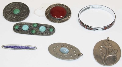 Lot 1198 - Four pewter Arts and Crafts brooches/pendants,...