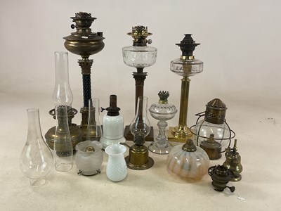 Lot 1215 - A group of oil lamps including two with glass...