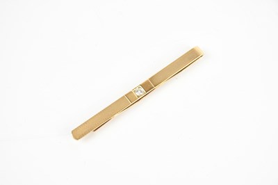 Lot 1609 - A 9ct textured yellow gold diamond set tie...