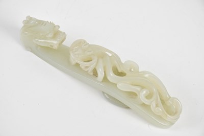 Lot 35 - A Chinese white jade 'dragon' belt hook,...
