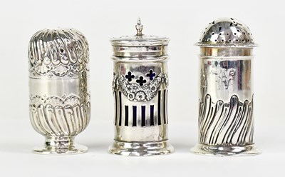 Lot 916 - Three Victorian hallmarked silver pepper pots,...