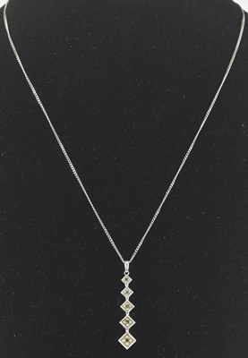 Lot 1247 - A 9ct gold graduated square drop pendant, each...