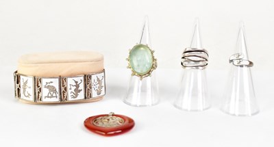 Lot 1040 - A white metal ring set with a large green oval...
