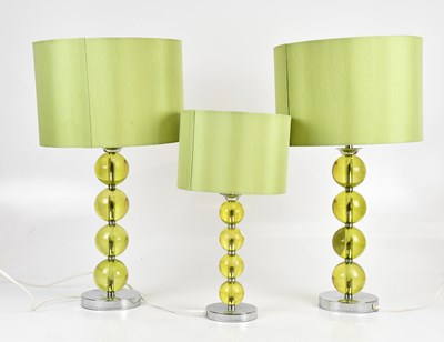 Lot 2418 - A pair of modern green plastic lamps, height...