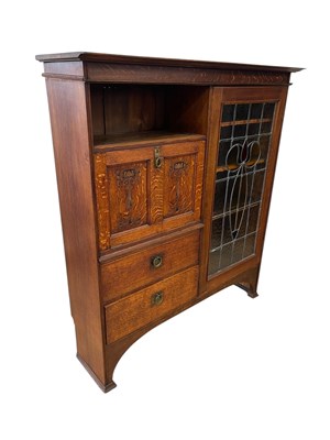 Lot 2137 - An Art Nouveau oak cupboard, with lead glazed...