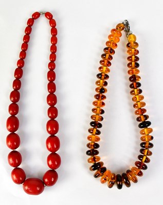 Lot 1091 - A substantial amber-style beaded necklace set...