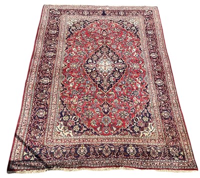 Lot 85 - A modern red ground Persian style floral...