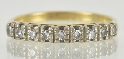 Lot 1189 - An 18ct gold half hoop diamond set ring, the...
