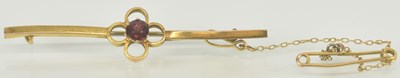 Lot 1301 - An amethyst claw set gold bar brooch with...