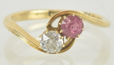 Lot 1188 - An 18ct gold diamond and pink stone crossover...
