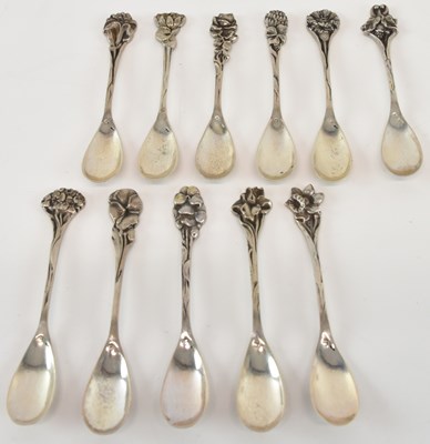 Lot 1091 - A set of eleven white metal condiment spoons,...