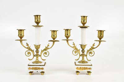 Lot 1418 - A pair of white metal and gilt marble twin...