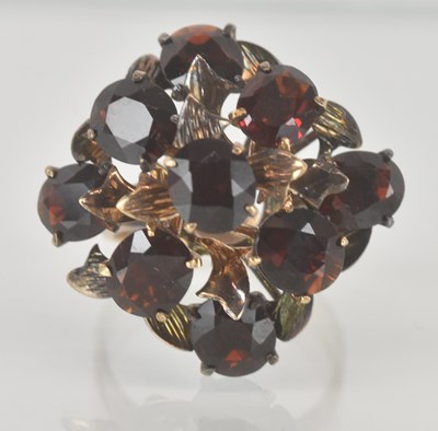 Lot 1205 - A vintage 18k claw set garnet cluster ring...