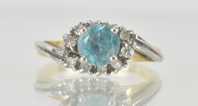 Lot 1206 - An 18ct gold topaz and diamond set ring, with...