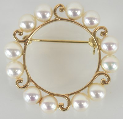 Lot 1290 - A circular open brooch marked '14k', with six...