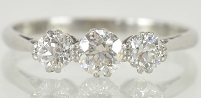 Lot 1150 - An 18ct white gold three stone diamond set...