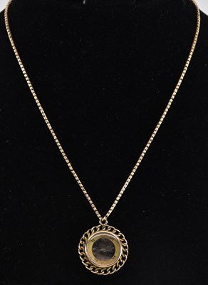 Lot 1227 - A 9ct yellow gold mounted compass pendant,...
