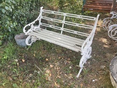 Lot 2347 - A white painted cast iron garden bench, the...
