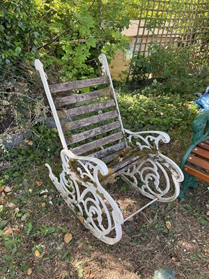 Lot 2342 - A white painted cast iron rocking garden chair.
