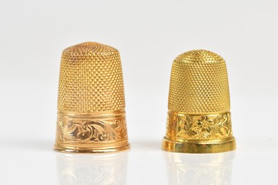 Lot 1341 - Two yellow metal thimbles, each cased,...
