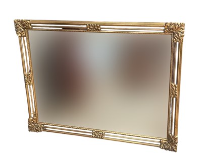 Lot 2296 - A modern gilt framed wall mirror with central...