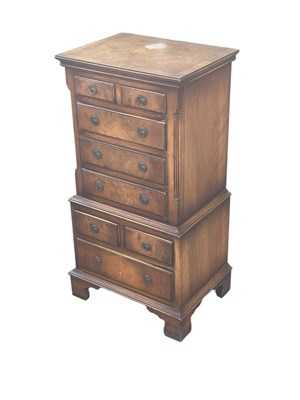 Lot 2144 - A reproduction miniature mahogany chest on...