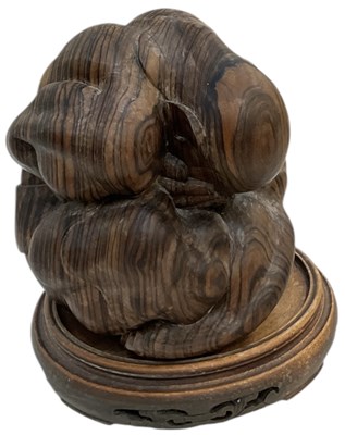 Lot 633 - A modern Oriental wooden carving of a crying...