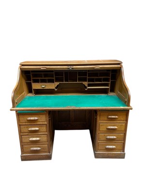 Lot 2280 - An early 20th century oak roll top desk, with...