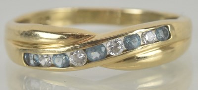 Lot 1208 - A 9ct gold dress ring, with crossover top, set...