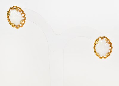 Lot 1102 - A pair of 9ct yellow gold earrings set with...