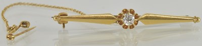 Lot 1299 - A gold bar brooch with central raised claw set...