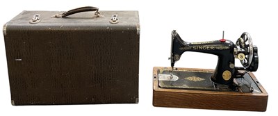 Lot 336 - A cased Singer sewing machine.