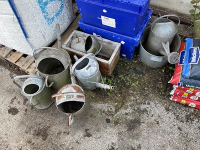 Lot 1398 - A collection of six galvanised watering cans,...