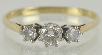 Lot 1309 - A 9ct gold three stone diamond set ring, size...