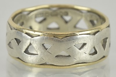 Lot 1198 - A 9ct gold ring, the open white gold Celtic...