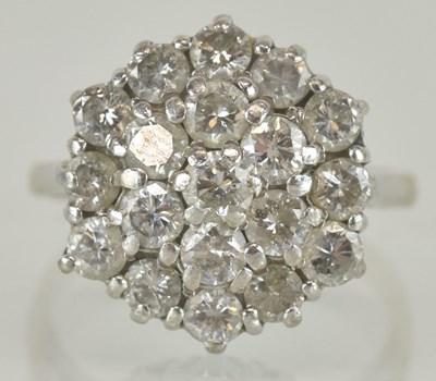 Lot 1147 - An 18ct white gold diamond cluster ring, the...