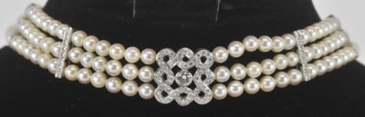 Lot 1212 - A vintage diamond and pearl choker, the three...
