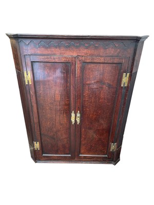Lot 2272 - An 18th century oak hanging corner cupboard,...