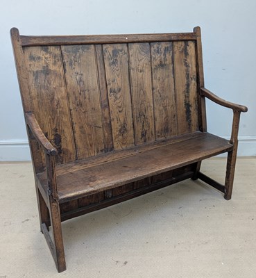Lot 2253 - An 18th century oak settle with panelled back,...